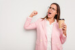 © Asier - Business caucasian woman holding a take away coffee isolated on white background raising fist after a victory, winner concept.
