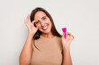 © Asier - Young caucasian woman holding menstrual cup isolated on white background excited keeping ok gesture on eye.