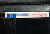 Fototapeta  - driving permit. Prawo jazdy portfel, Polish driving license in a black wallet. Polish and european union emblem. Driver's license in Poland in a leather wallet