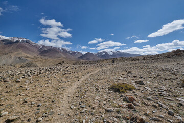 Two hikers walking on a footpath in Markha valley, Ladakh