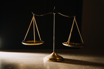 Business and lawyers discussing contract papers with brass scale on desk in office. Law, legal services, advice, justice and law concept picture with film grain effect