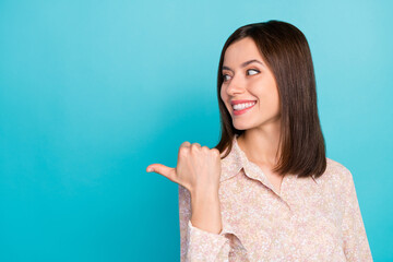 Sticker - Close up photo of pretty young lady point look advert space dressed stylish smart casual outfit isolated on aquamarine color background