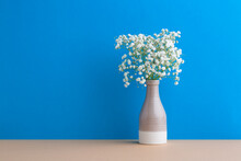 Small White Flowers On A Blue Background. Soft Home Decor. Gypsophila Flowers. White Flowers In A Vase. Retro Style.