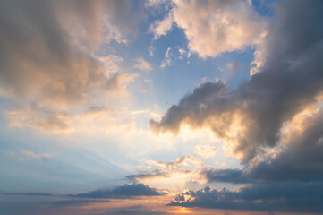 Wall Mural - sunset / sun rise sky with rays of yellow and red light shining clouds and sky background and texture