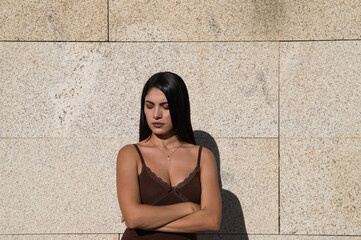 Young beautiful woman making different expressions of surprise, anger or happiness and sadness on a gray background. Concept expressions and gestures.