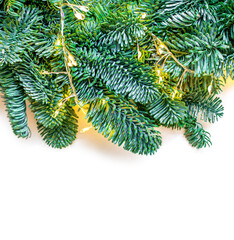 Wall Mural - christmas tree border isolated on white background. fir tree branches with sparkling golden lights g