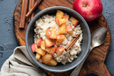 Fototapeta Desenie - Oatmeal porridge with apple and cinnamon in bowl, top view. Healthy breakfast meal