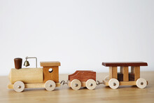 Wooden Toy Train With One Carriage On Wooden Table With White Background And Copy