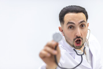 Close up photo of male mature doctor posing at camera with a stethoscope.