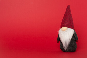 Small Christmas dwarf on color background