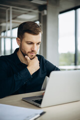 Business man working on laptop at his desk