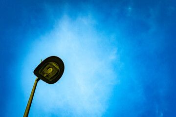 Black street lamp, lamppost, streetlight; with blue sky background