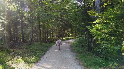 Sticker - Slow motion video of a black woman with backpack enjoying while hiking alone through the forest.