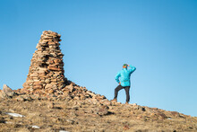 Hiker And Large Stone Cairn Overlooking Colorado Prairie, Soapstone Prairie Natural Area Near Fort Collins