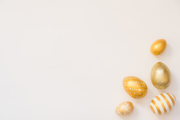 Frame of Easter decorated eggs isolated on white background. Minimal easter concept. Happy Easter card with copy space for text. Top view, flatlay.