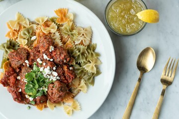 Poster - Top view of a gourmet bowl of pasta with meatballs and sauce