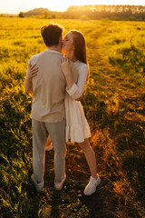 Wall Mural - vertical portrait of happy young woman with closed eyes and man in love embracing, kissing, stroking