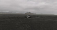 aerial shot of dc 3 plane wreck in iceland black beach with mountains on background iceland