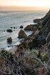 Vertical shot of rocks and cliffs in El Matador Beach Malibu with waves washing the coastline