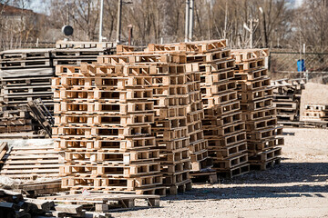 Stack of wooden pallets in warehouse. Industrial logistics and t