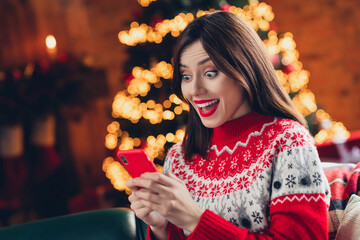 Canvas Print - Portrait photo of young funny excited christmas girl wear ugly sweater hold phone surprised got invite new year party with hollywood stars indoors