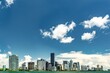 Scenic display of Miami skyline with its skyscrapers against the blue sky with fluffy clouds