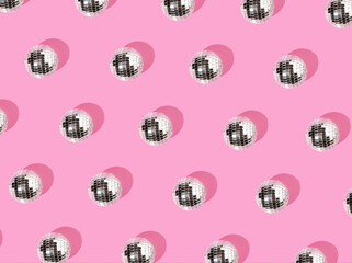 Disco balls on a pastel pink background..The concept of minimal entertainment. Flat lay.