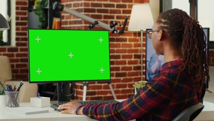 Poster - african american woman looking at computer with greenscreen template, working with blank copyspace c