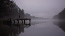 Girl Walking On Pier In Misty Weather