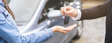 Business Car Rental, Sell Or Buy Service, Dealership Hand Of Agent Dealer, Sale Man Giving Auto Key Of Vehicle To Customer Renter, Buyer Young Woman Receiving, Client Or Tenant, Transfer Automobile.