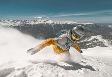 Close Up Photo Of Fast Snowboarder In Cloud Of Powder Snow At Ski Slope