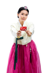 Sticker - Asian woman wearing a traditional Korean national costume, Hanbok, standing while holding a credit card