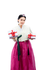 Sticker - Asian woman wearing a traditional Korean national costume, Hanbok, standing while holding a gift box