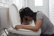 Woman drunk hangover puke in toilet bowl. Female have abdominal pain, nausea, dizziness, nausea, vomit due to food poisoning.