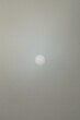 Vertical shot of the sun beyond the mist