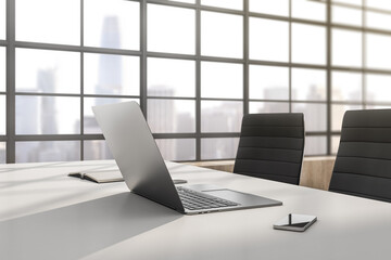 Poster - Close up of modern designer office interior with laptop, smartphone, book and window with city view. 3D Rendering.