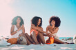 © C Haas/peopleimages.com - Friends, sunscreen and relax at beach, happy and summer holiday, travel and blue sky in Miami, happy and smile. Blaxk women, vacation and ocean vacation, happiness and afro with skincare and safety