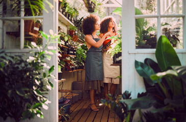 Tablet, plants and women, florist shop and nature in retail store, service and eco friendly market. Female seller staff check flowers, leaves and digital planning for sustainable startup management