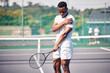© L Ismail/peopleimages.com - Sports, tennis and arm pain on court after training, game or match outdoors. Healthcare, tennis player and injured black man or athlete with muscle pain or inflammation after exercise or workout.