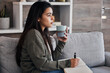 © L Ismail/peopleimages.com - Relax, thinking and woman journaling with coffee for self care on the living room sofa of her house. Idea, tea and girl with creativity in a notebook, green tea and writing in diary on the couch