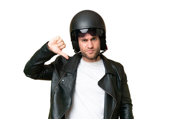 Wall Mural - Young caucasian man with a motorcycle helmet isolated on green chroma background showing thumb down with negative expression