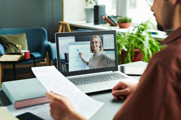 Poster - Mature confident teacher on laptop screen pointing at whiteboard during explanation of new subject of English grammar to online audience