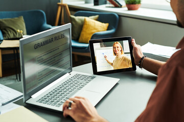 Poster - Focus on tablet screen with confident teacher standing by whiteboard and explaining new English grammar rules to online audience at lesson