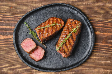 Wall Mural - Closeup view of grilled beef steak on a plate