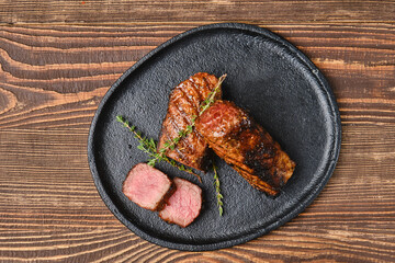 Wall Mural - Overhead view of grilled beef brisket flat steak on wooden table