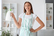 © Pixel-Shot - Young housewife with bottle of detergent at home
