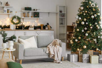 Canvas Print - Interior of kitchen with sofa, Christmas tree and glowing lights