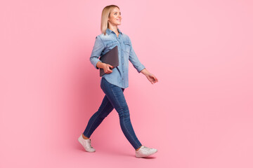 Full size photo of cute young lady hold laptop go wear shirt jeans footwear isolated on pastel background