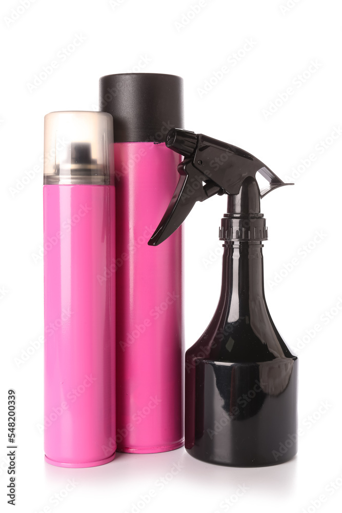 Bottles of hair spray on white background