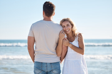 Wall Mural - Couple, hug and love for travel, beach or summer vacation relaxing or bonding together in the outdoors. Woman holding man in loving embrace with smile for happy relationship or traveling by the ocean